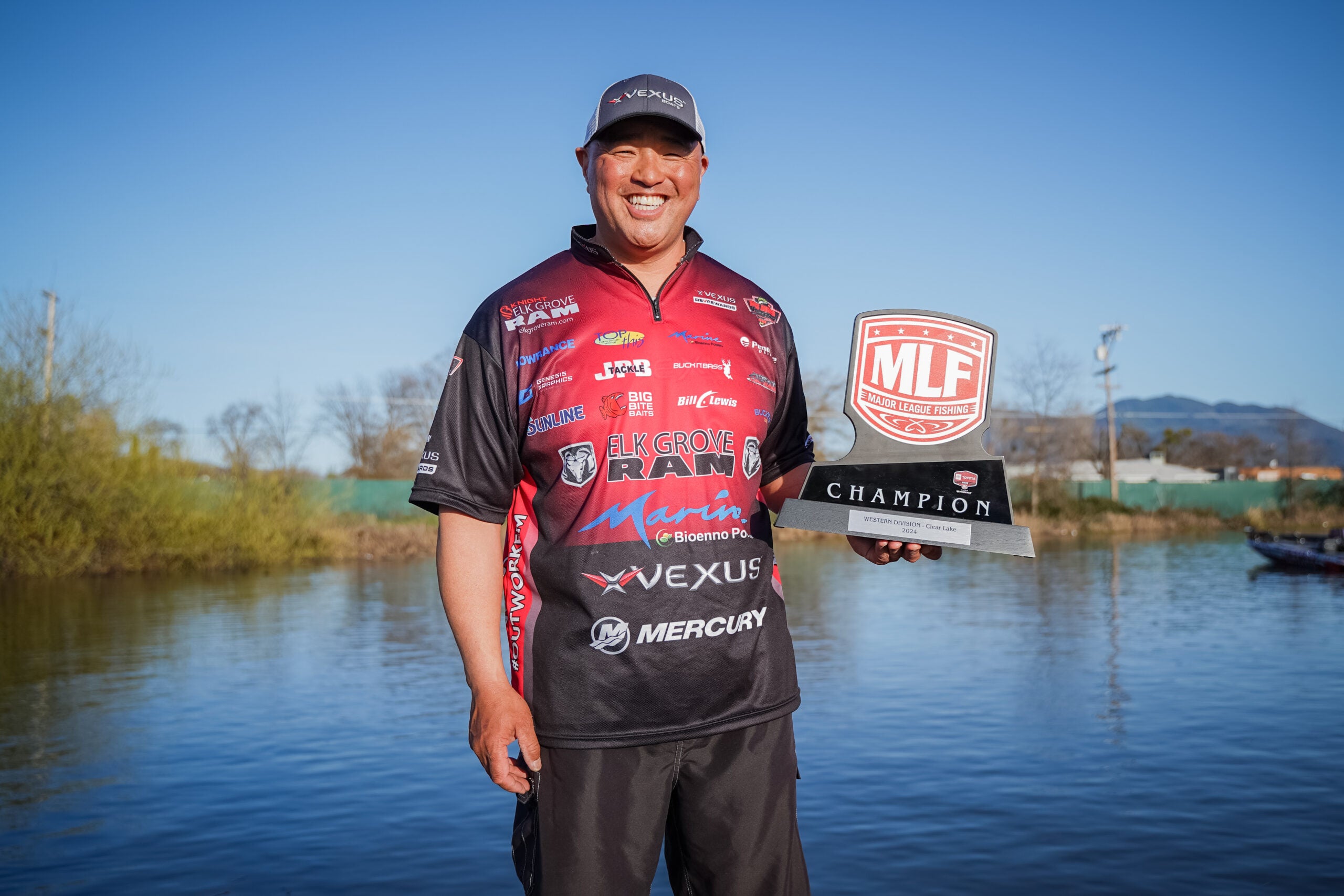 ken Mah holding his Major League Fishing trophy after his win at Clearlake in California.